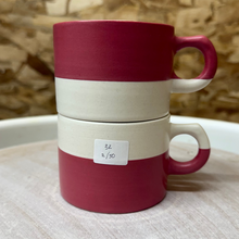 Load image into Gallery viewer, Stackable red and white mugs on a wooden surface
